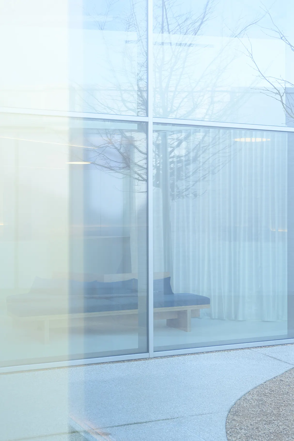 Lichte glazen hal van De Orthodontist in Veurne met wachtbank achter glas