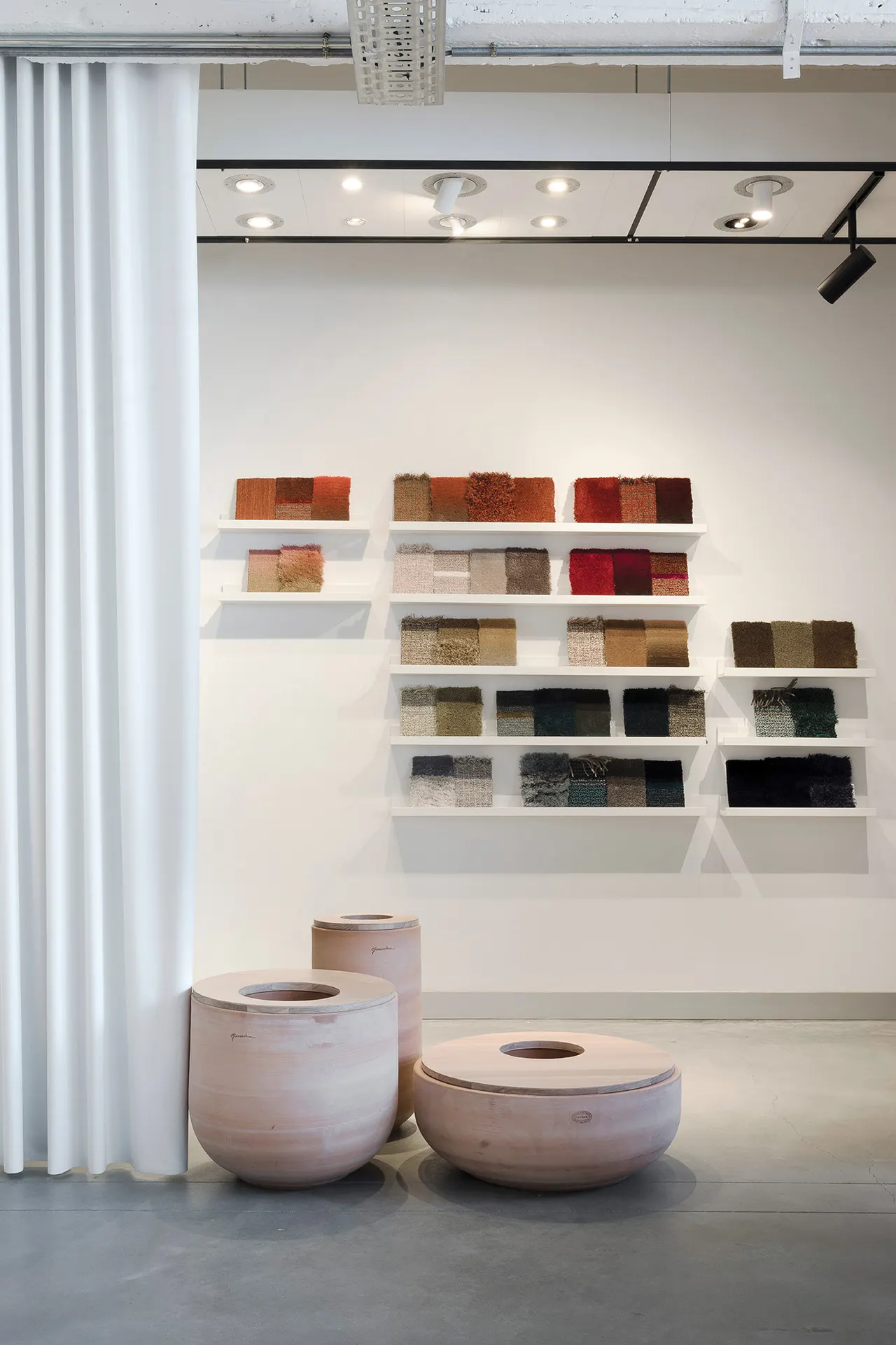 Wandrek met textielstalen en ronde poefs